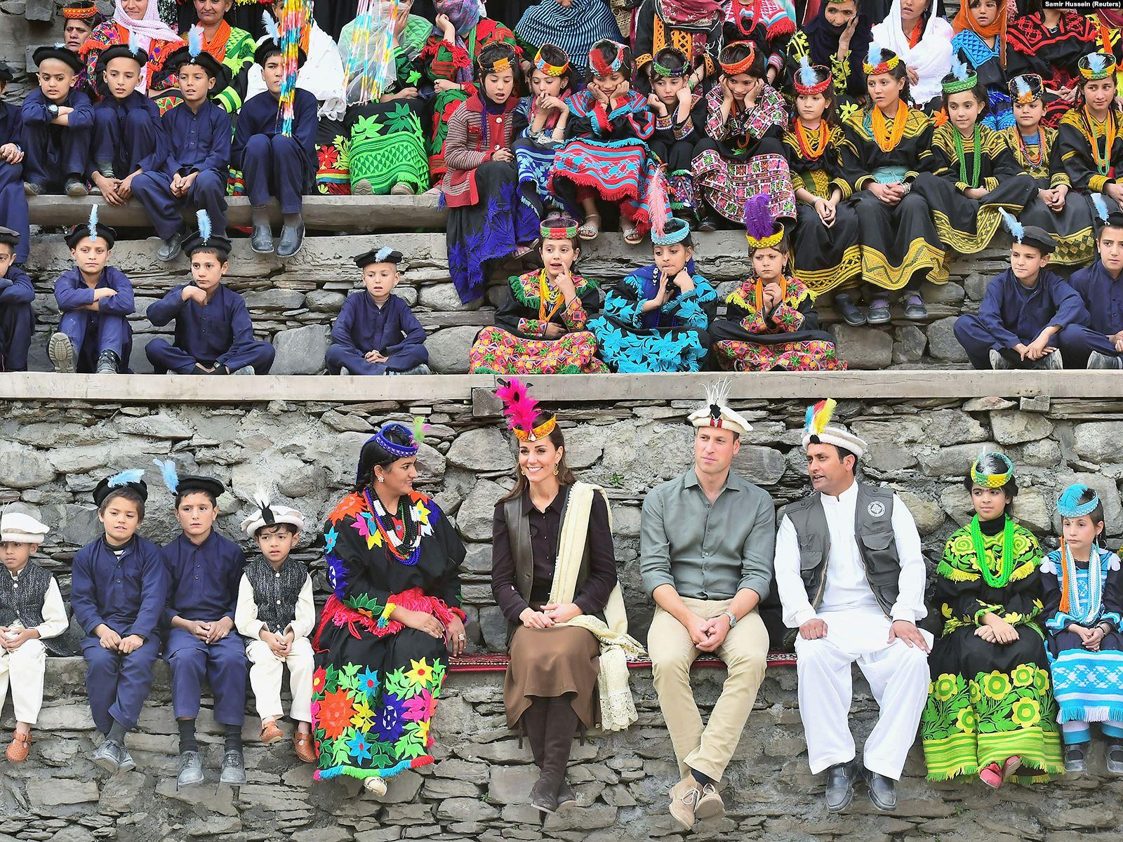 The royal pair wait for dancing to begin at a settlement of the Kalash people in the Chitral District.